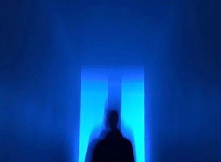 A figure in front of a lit doorway, used for the page on adding engineers to a development team